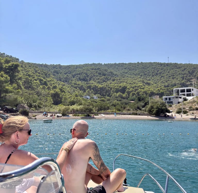 Couple applying sun protection on a boat at Krusica Bay on Solta during a private boat tour from Split