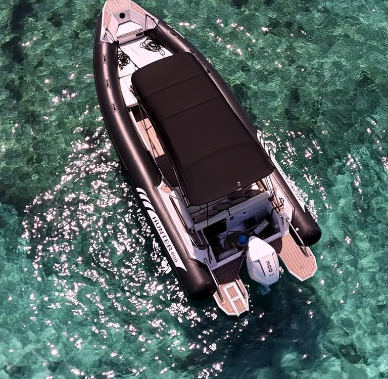 Premium black Hunter Pro 800 RIB drone view in turquoise waters of Blue Lagoon during a private boat tour from Split.