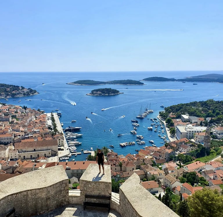 Man at Fortica Fortress in Hvar overlooking Hvar town and Pakleni Islands during private boat tour from Split.