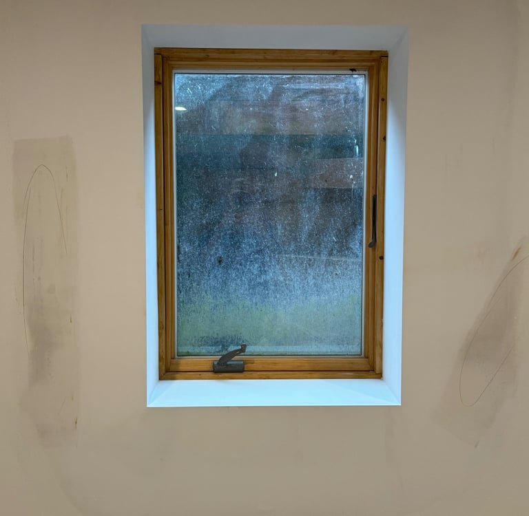 repaired drywall around window in residential basement