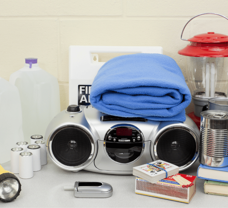 Florida hurricane supplies with water jug, radio, blanket, flashlights, candle, matches, first aid 