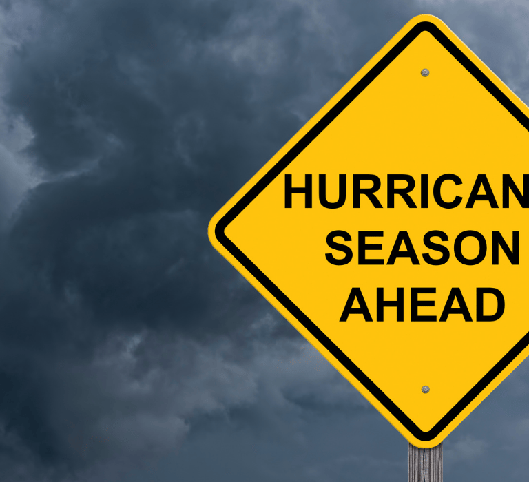 Yellow sign in stormy weather that says, Hurricane season ahead