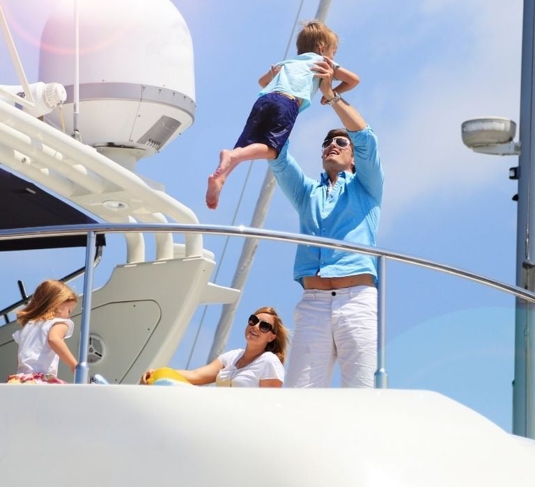 family on large yacht having fun