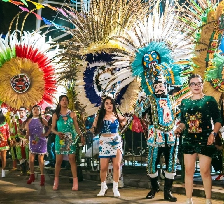 colorful parade with people standing on a float