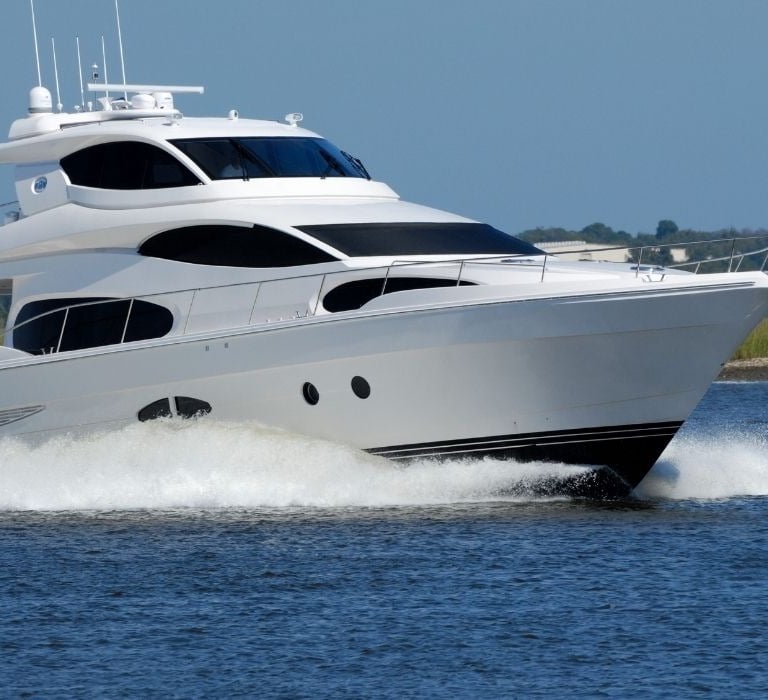 large white yacht running through water
