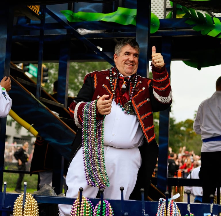 man dressed as pirate with armful of beads to throw