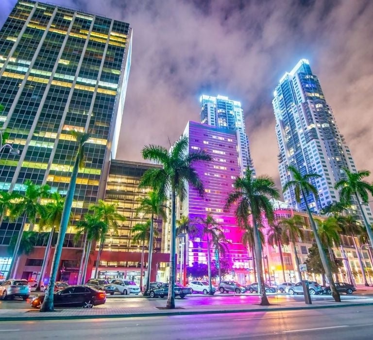 city of miami at night with colored lights