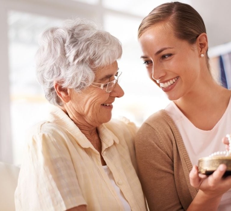 senior woman laughing with daughter