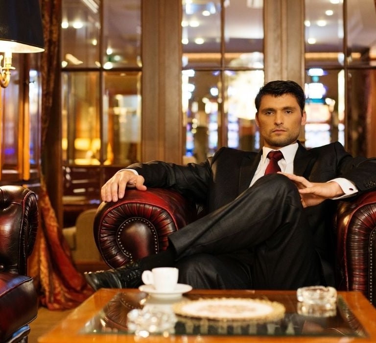 wealthy young man sitting in a rich office