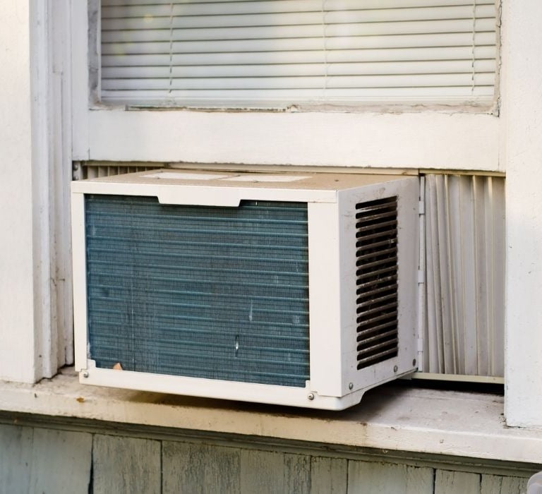 window unit air conditioner in old house window