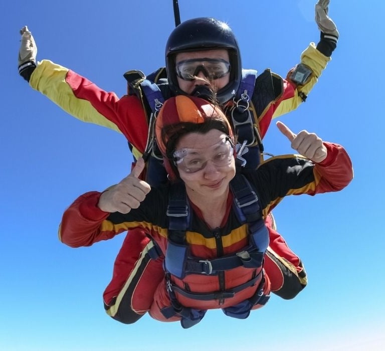 woman parachuting with instructor