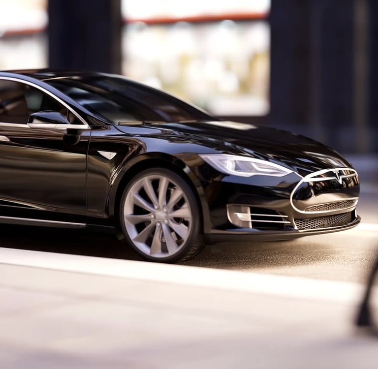 A sleek black Tesla Model S luxury electric sedan parked on a modern city street.
