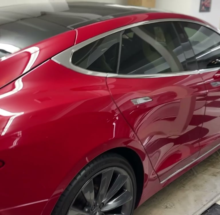 ceramic coating of a high end red tesla that is glossy