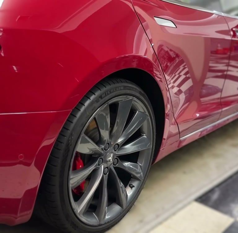 ceramic coating of red tesla in detailing garage