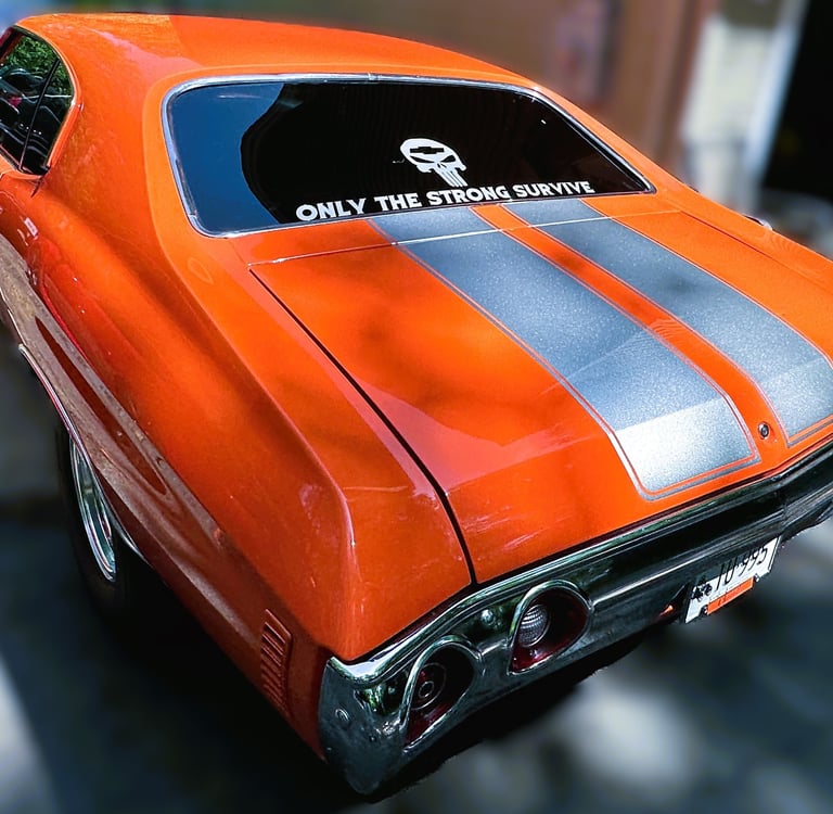 mobile detailing of a orange muscle car with grey stripes glossy in the sun