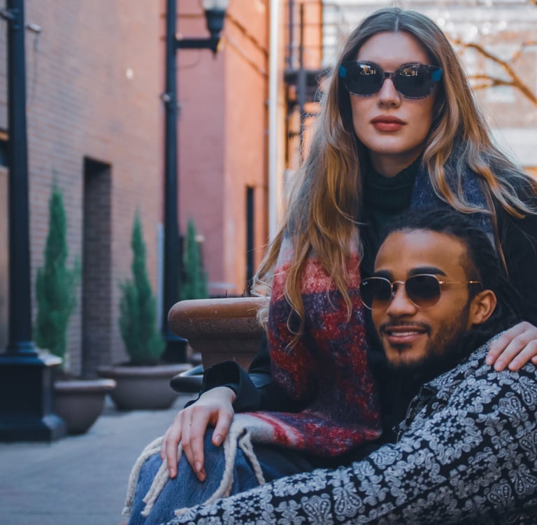 Man and woman modeling stylish sunglasses in downtown Fort Collins