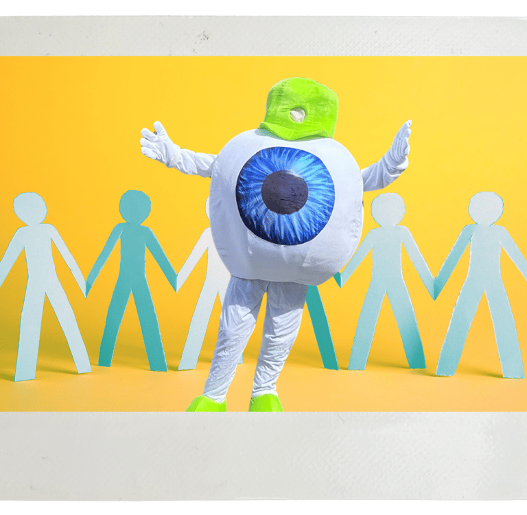 Edge Optics' eyeball mascot standing in front of people cutouts