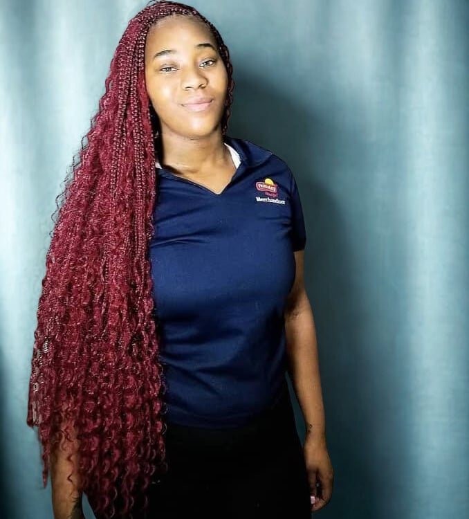 a woman with long red boho braids hairstyle