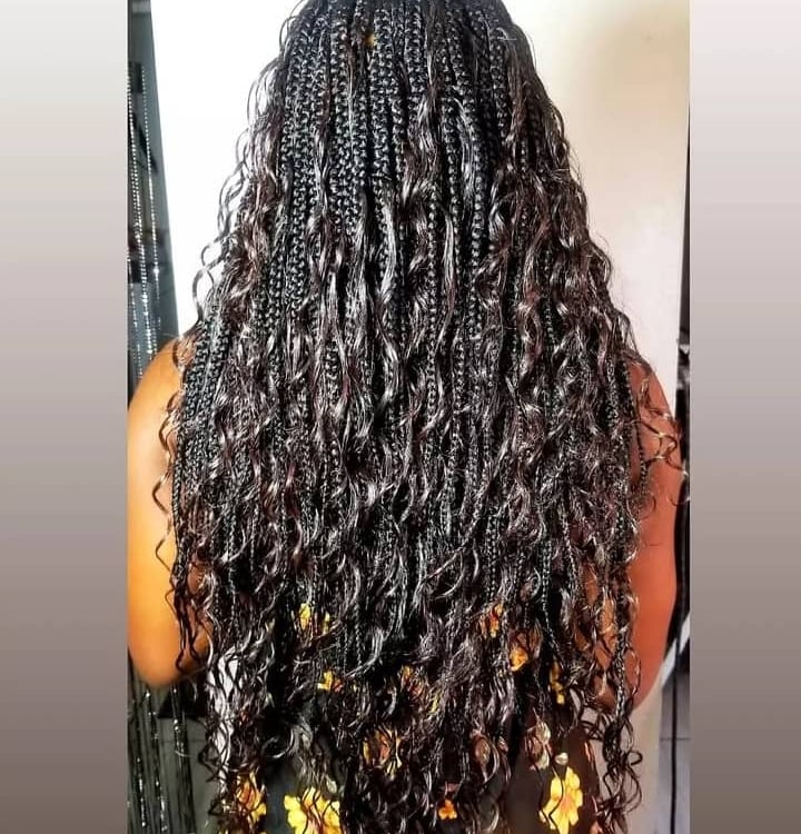 a woman with curly goddess braids