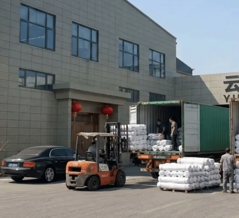 Textile factory loading fabric shipments at woven fabric manufacturer