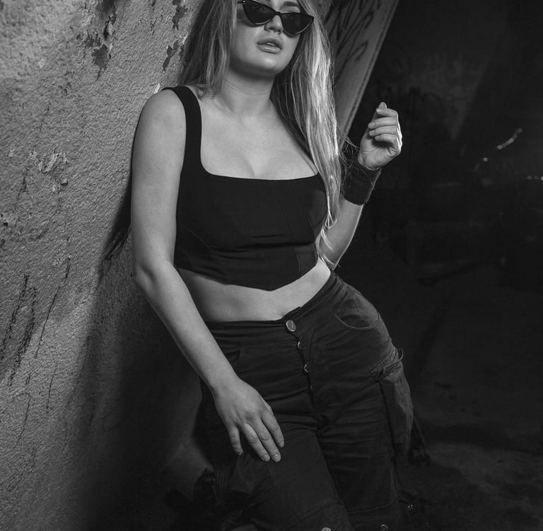 Dj Kat (Kat Bendis) in a photoshoot with black and white styling, wearing sunglasses