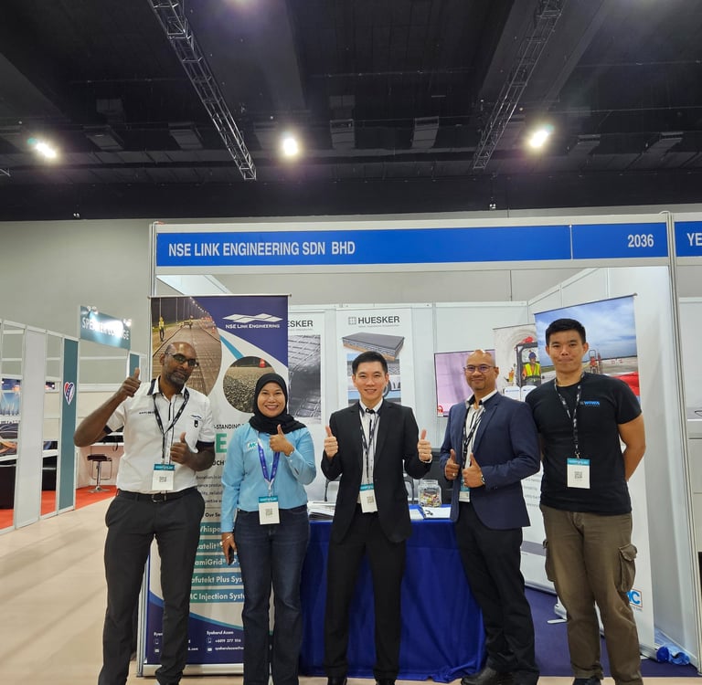 NSE Link Engineering team posing at their professional trade show booth during a construction industry exhibition.
