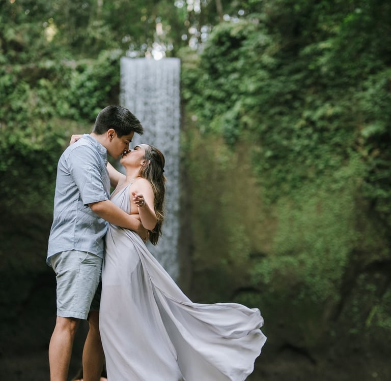 Romantic prewedding couple with flowing dress at Tibumana Waterfall Bangli Bali