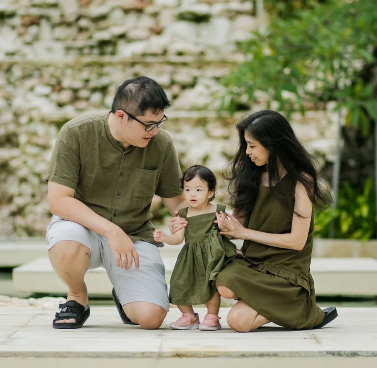 Family portrait surrounded by tropical gardens at The Apurva Kempinski Bali in Nusa Dua