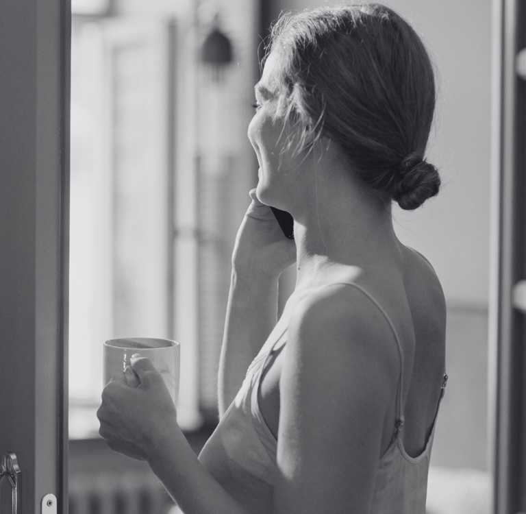 A woman speaking on the phone to someone she is dating instead of texting.