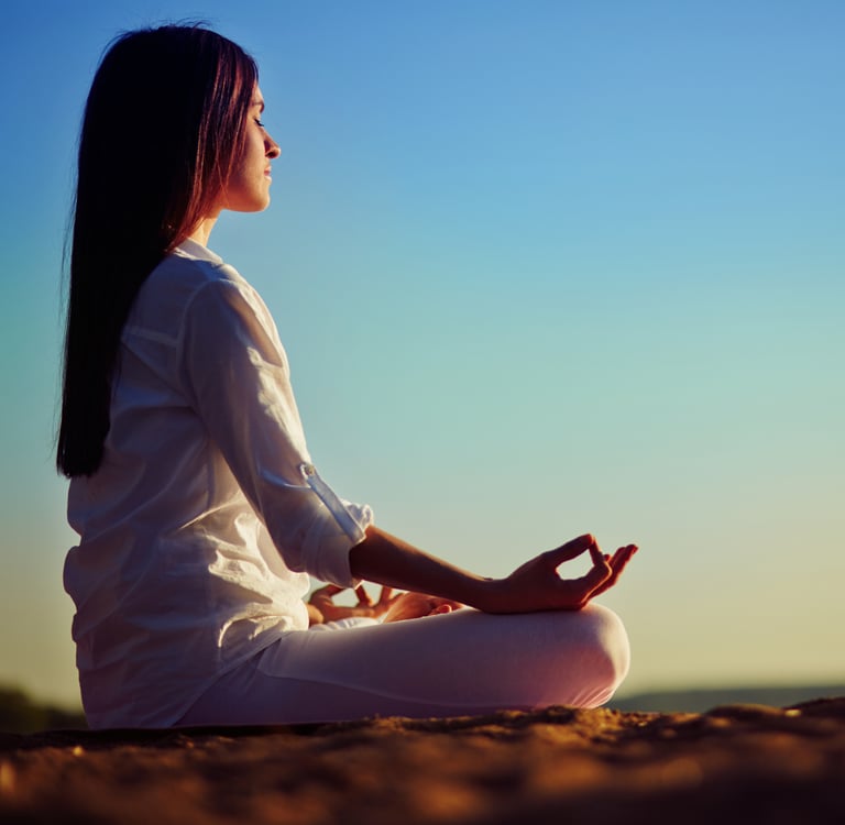 a woman sitting in a meditation position