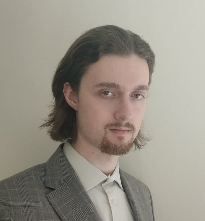 a man with a beard and a suit jacket