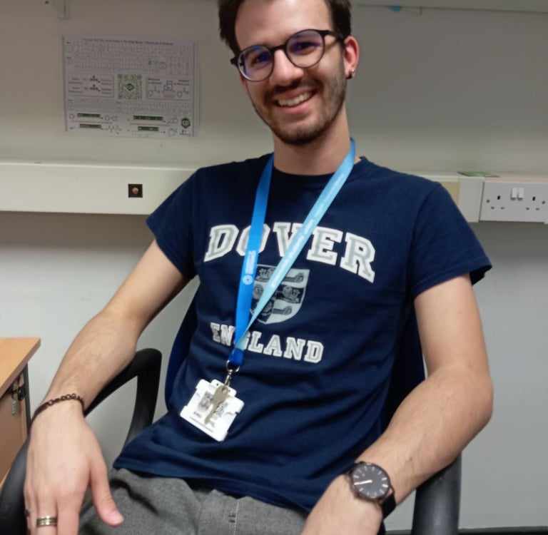 a man sitting in a chair with a blue lanyard lanyard lanyard lan