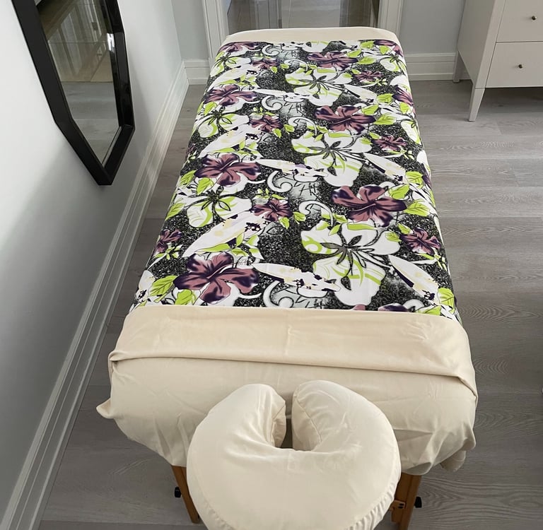 a massages by sophia massage table with a large floral print