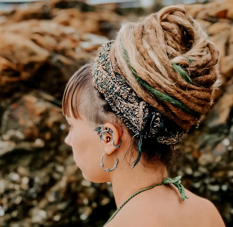 a woman and a dreadlock bun at the beach