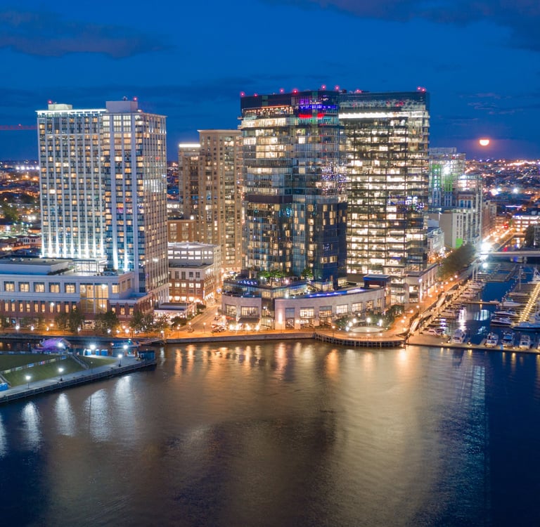 The buildings are illuminated in the downtown urban core of Baltimore Maryland