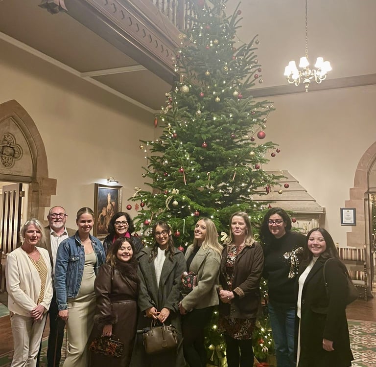 Claire Nash Solicitors team standing by a decorated Christmas tree