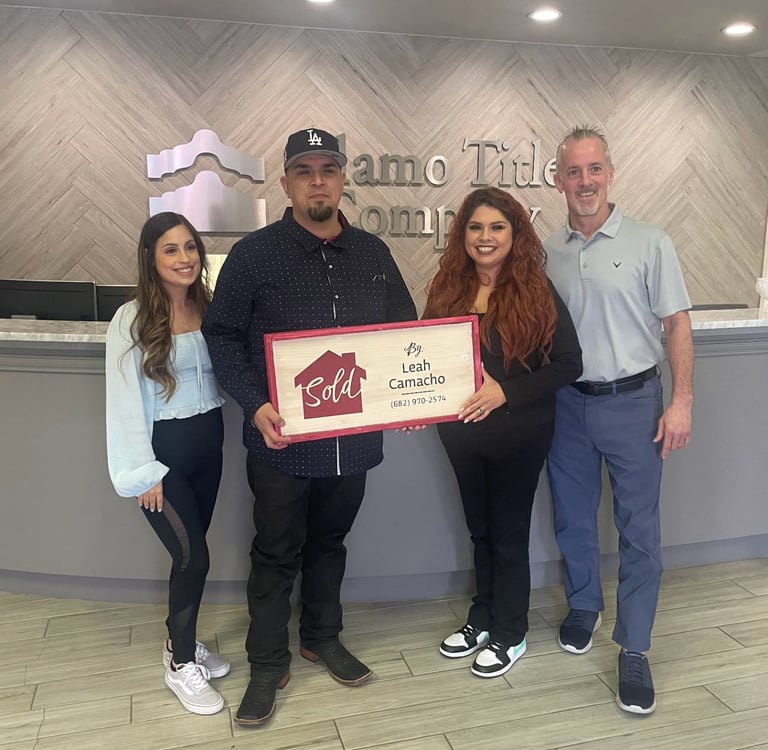 a man and woman standing in front of a sign that says,'welcome to