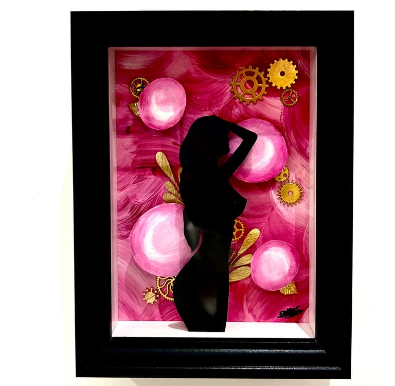 a woman in a black dress standing in front of a pink flower