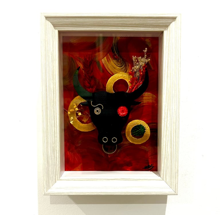 a picture of a bull headdressuck with a red background