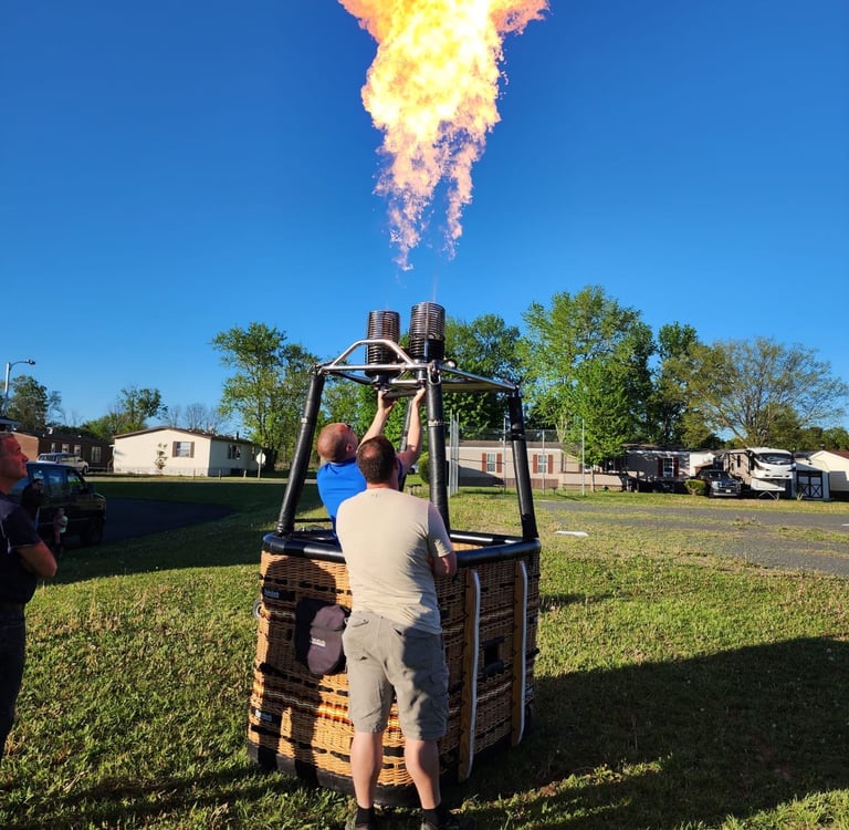 a man is standing in front of a hot air balloon