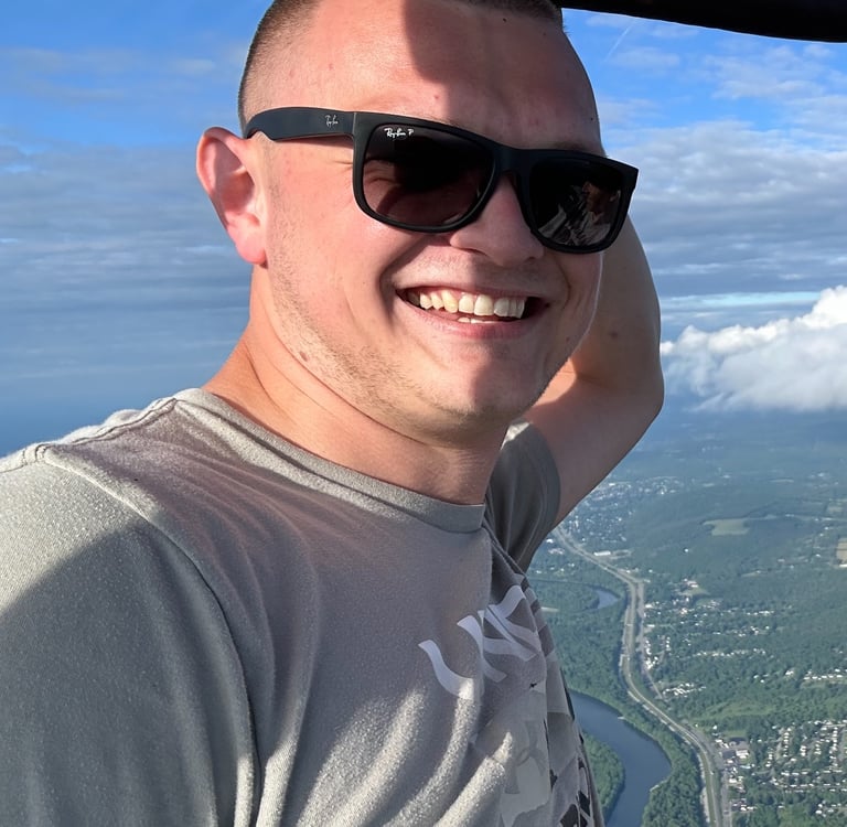 a man in sunglasses and sunglasses is smiling and holding a bat