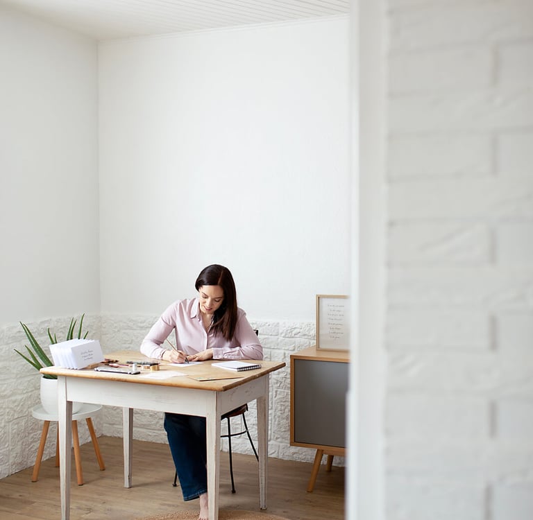 a woman sitting at a table with papers