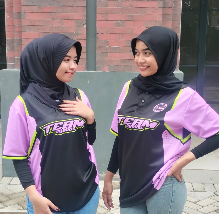 two women in hijab clothing standing next to each other