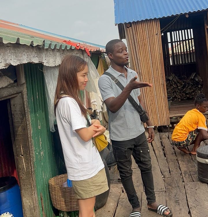 Dahomey African Tours Guide leading Tourists in Ganvie Stilt Village in Benin