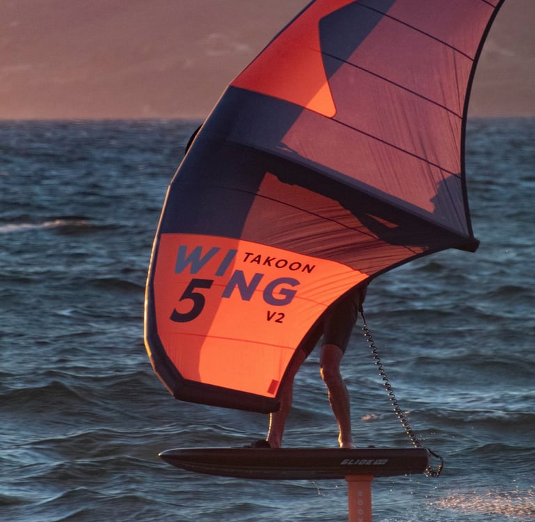 orange Wingfoil during sunset