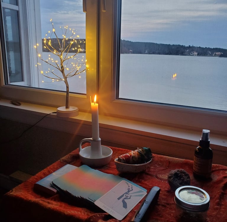 An altar ready for a psychedelic therapy session, with sage, a candle burning and oracle cards