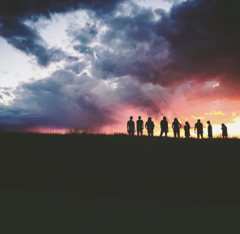 a group of people standing on a hill top