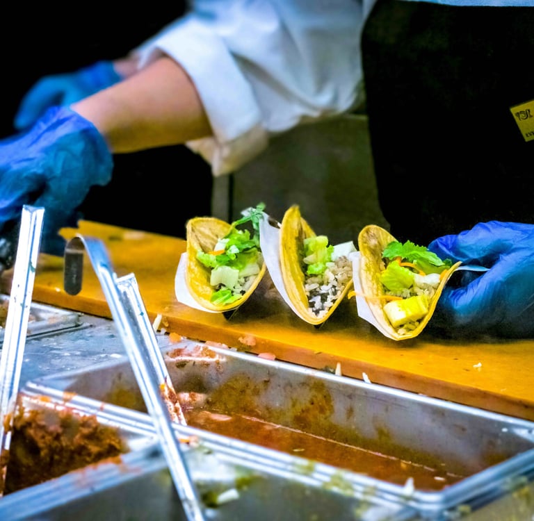 a person in gloves and gloves holding a knife and fork