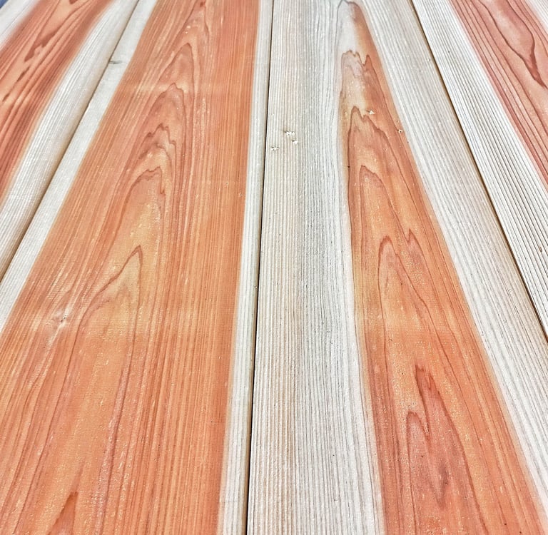 Polished sugi wood planks with natural orange grain patterns and vertical texture for flooring.