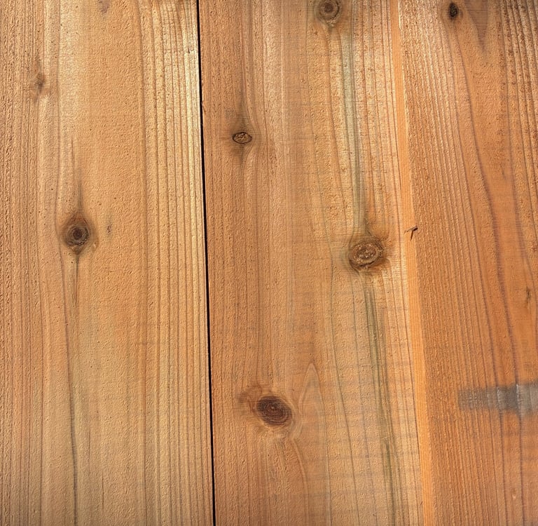 Natural cedar wood planks with visible grain patterns and knots for rustic lumber texture.